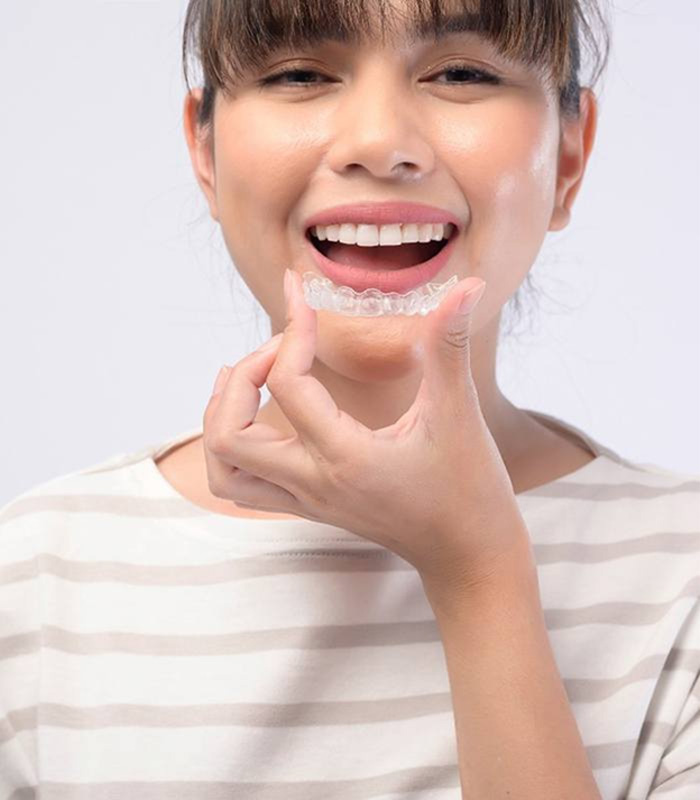 Young woman with SureSmile aligners in Jonesboro