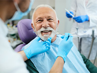 An older man seeing his dentist for dentures