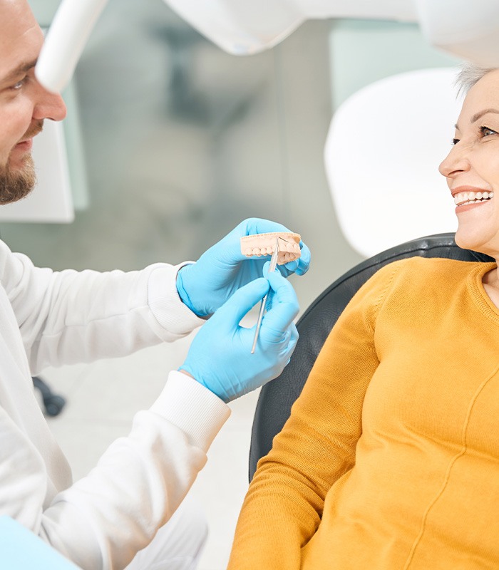 a dental patient speaking with her dentist about dentures